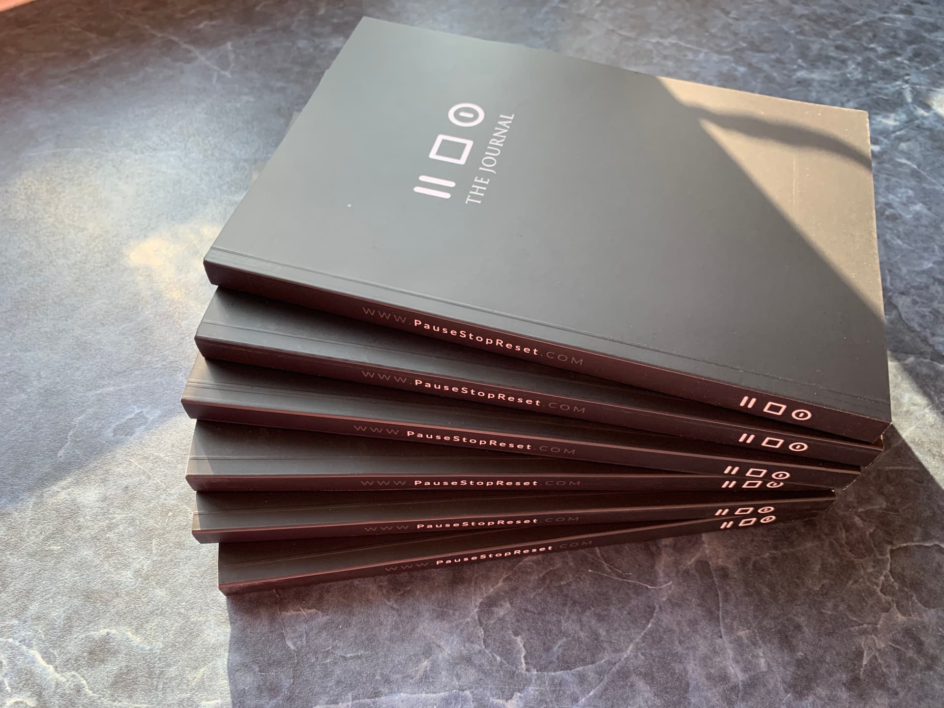 A stack of Pause to Reset journals