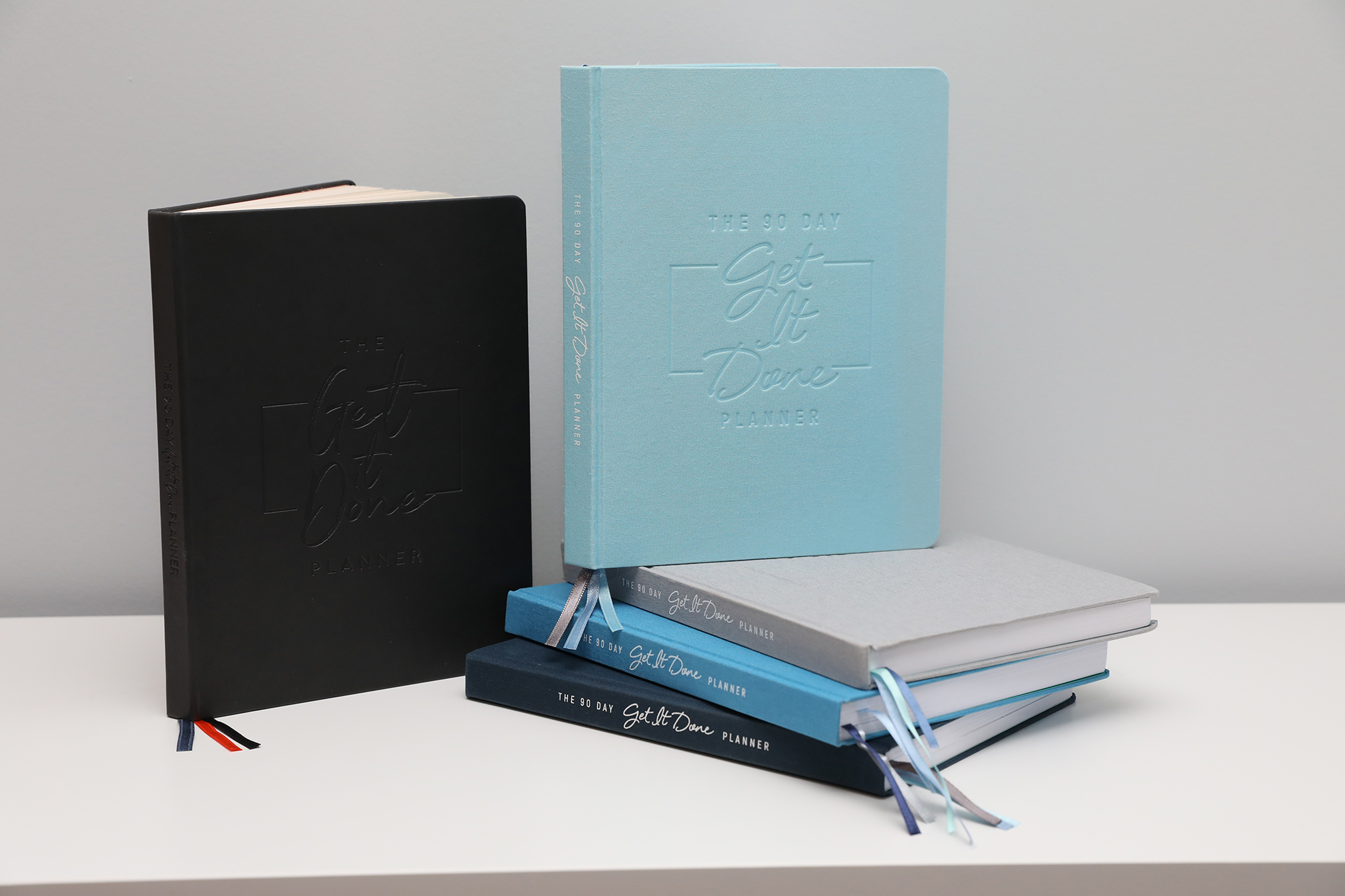 The 90 Day Get It Done planners in a range of cover colours